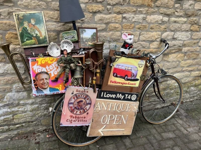 Antique shop in stow on the wold showing old bike and bric a brac 